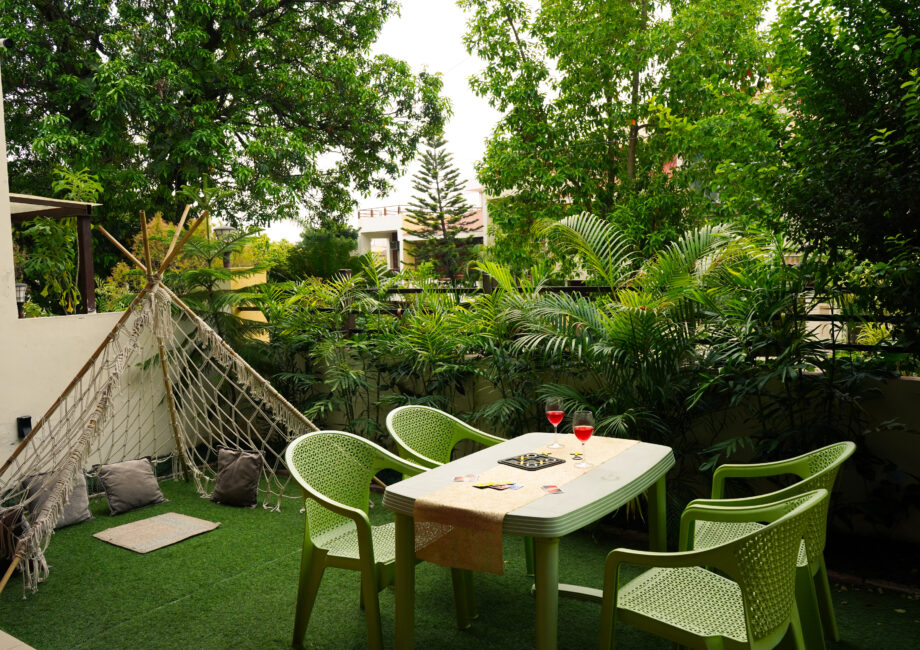 Garden lounge with hammock-style macrame teepee and chairs