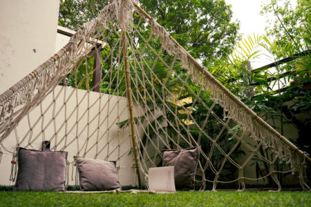 Cozy reading nook under the macramé teepee with cushions in the private garden Ground Floor Haven, The Basera Rishikesh.
