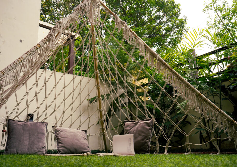 Cozy reading nook under the macramé teepee with cushions in the private garden Ground Floor Haven, The Basera Rishikesh.