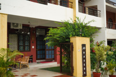 House front with flowers and Himalayan backdrop