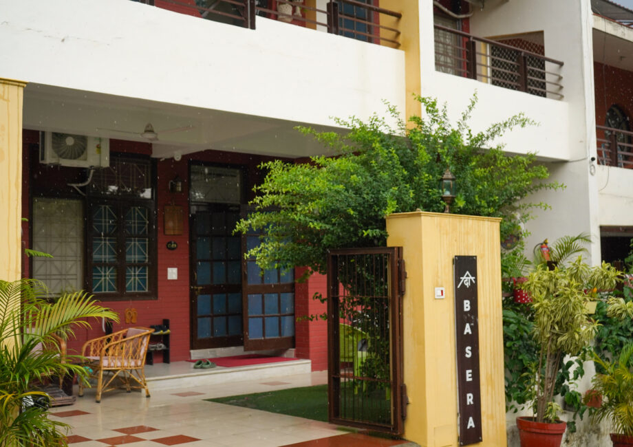 House front with flowers and Himalayan backdrop