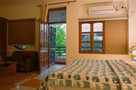 Wide room with bed, sofa nook and balcony door