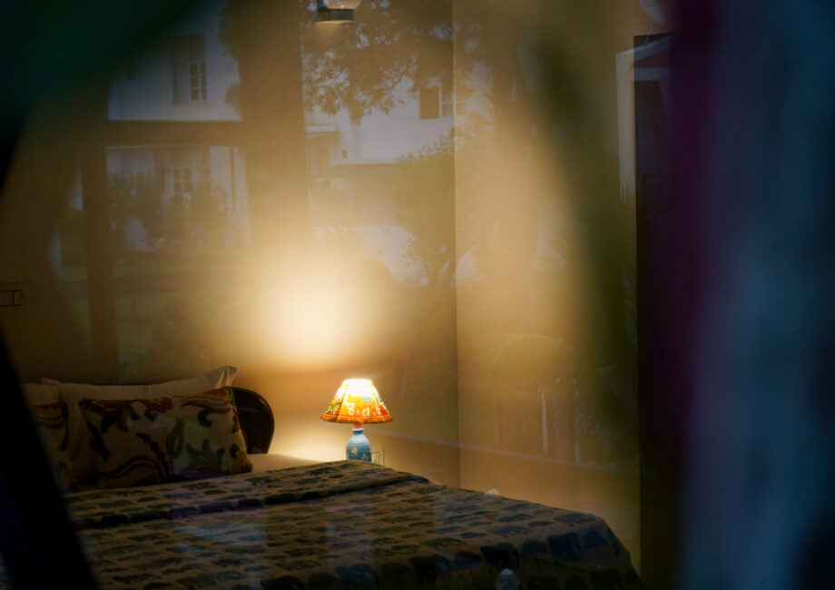 Artistic elephant-themed bedside lamp softly illuminating a cozy bedroom corner at The Basera