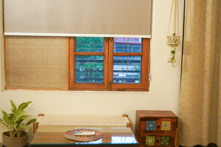 Window sitting corner with rustic table, indoor plant, and natural light