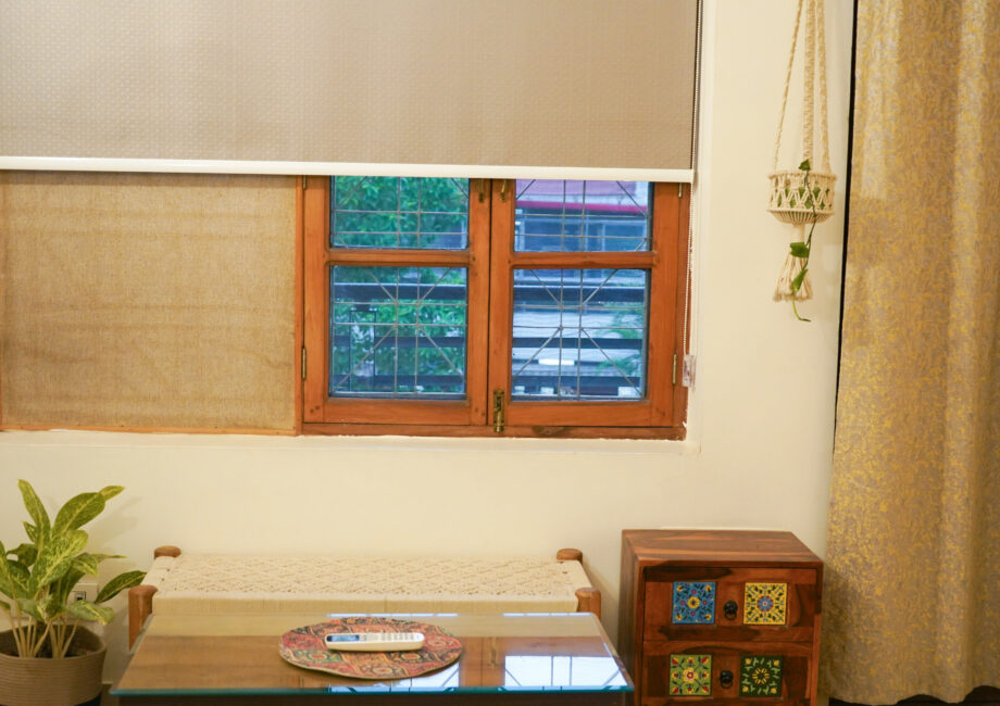 Window sitting corner with rustic table, indoor plant, and natural light
