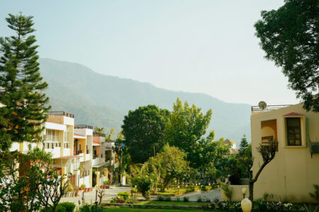 Neighborhood view with gardens and Himalayan foothills near The Basera Rishikesh.