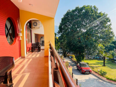 Balcony view over driveway, lawn and large tree