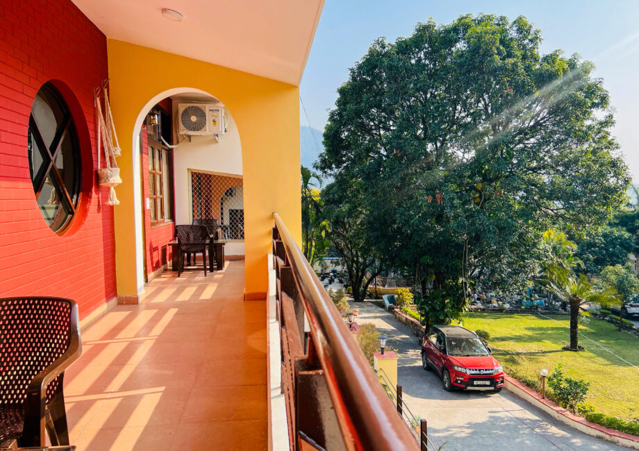 Balcony view over driveway, lawn and large tree