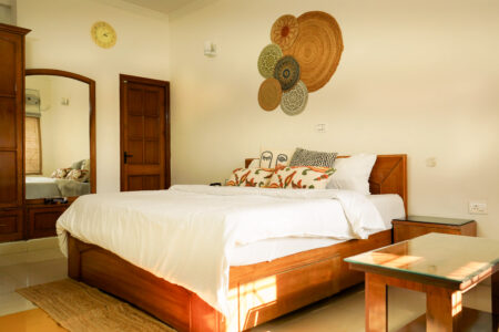 Bohemian suite king bed with jute wall art, layered textiles, and sunlight