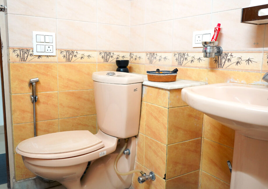 Compact bathroom with mirror, shower, and washbasin, designed for practical comfort.