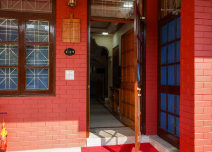 Main door entrance to The Basera villa revealing an inviting hallway and modern wooden interiors