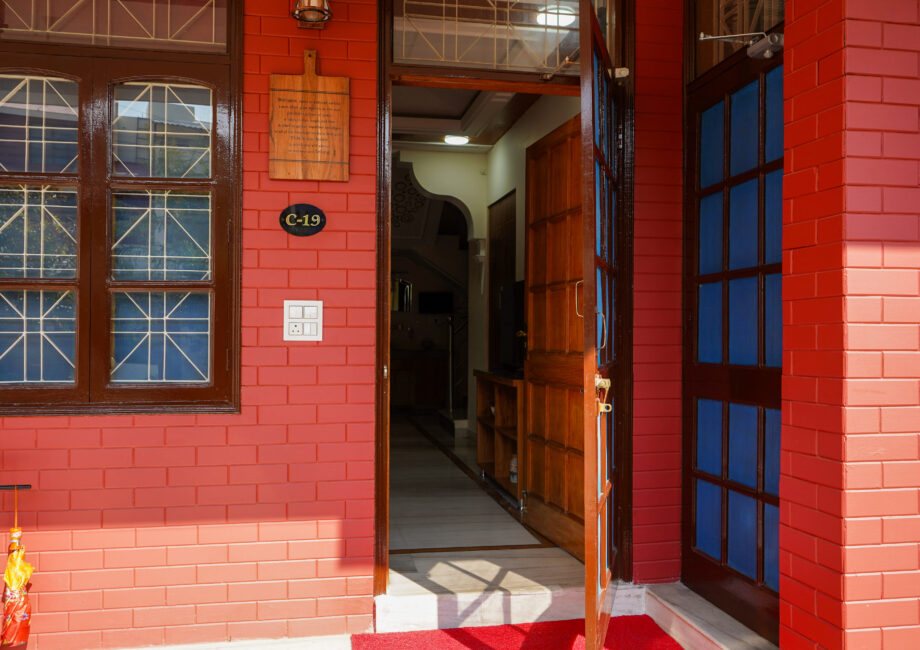 Main door entrance to The Basera villa revealing an inviting hallway and modern wooden interiors